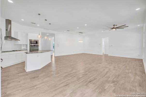 Empty room, Interior, Kitchen, Pendant Lights, Recessed Lighting, Stainless Steel Appliances, Wood Texture Flooring