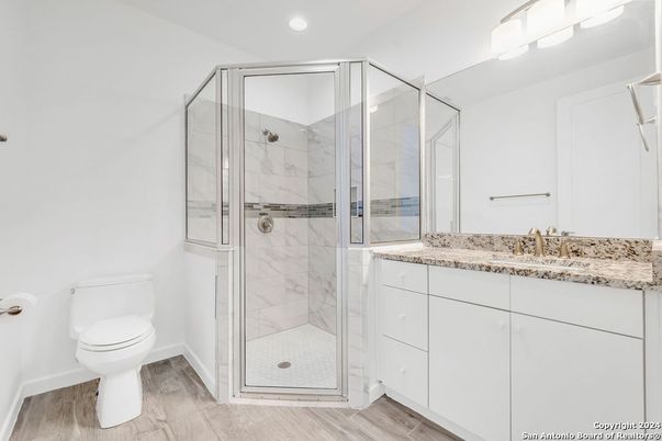 Bathroom, Glass Shower, Interior, Marble Walls, Recessed Lighting, Wood Texture Flooring