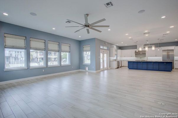 Empty room, Interior, Kitchen, Pendant Lights, Recessed Lighting, Stainless Steel Appliances, Wood Texture Flooring