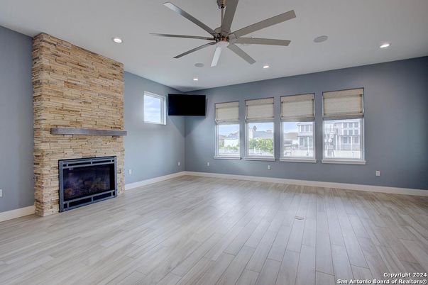 Empty room, Fireplace, Interior, Recessed Lighting, Stone Walls, Wood Texture Flooring