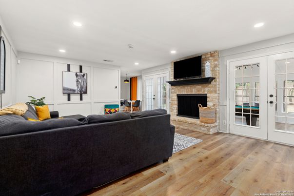 Fireplace, Interior, Living room, Recessed Lighting, Stone Walls, Wood Texture Flooring