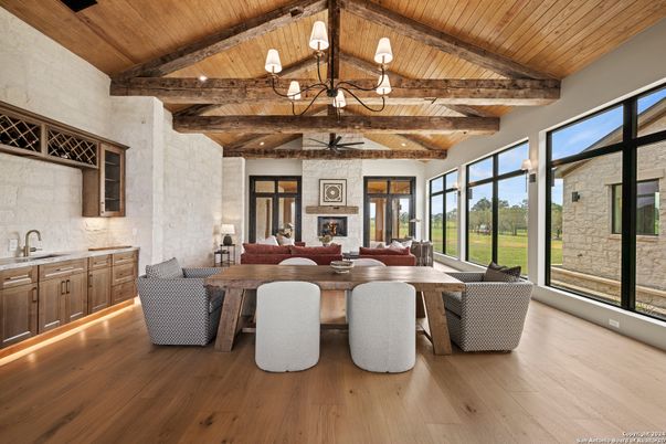 Chandelier, Dining room, Fireplace, Interior, Living room, Stone Walls, Wooden Beams, Wooden Ceilings, Wood Texture Flooring