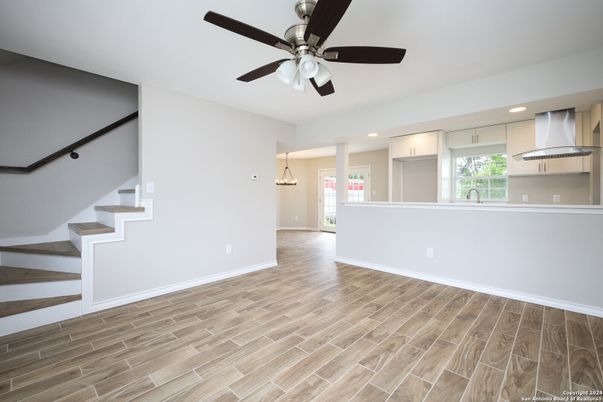 Empty room, Interior, Kitchen, Pendant Lights, Recessed Lighting, Stainless Steel Appliances, Wood Texture Flooring