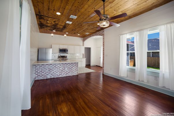 Empty room, Interior, Kitchen, Recessed Lighting, Stainless Steel Appliances, Wooden Ceilings, Wood Texture Flooring