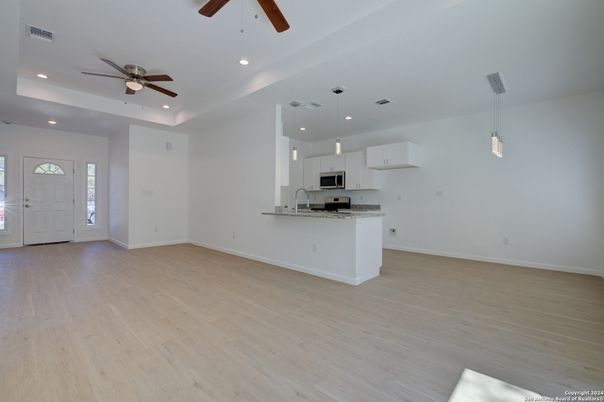Empty room, Interior, Kitchen, Pendant Lights, Recessed Lighting, Stainless Steel Appliances, Wood Texture Flooring
