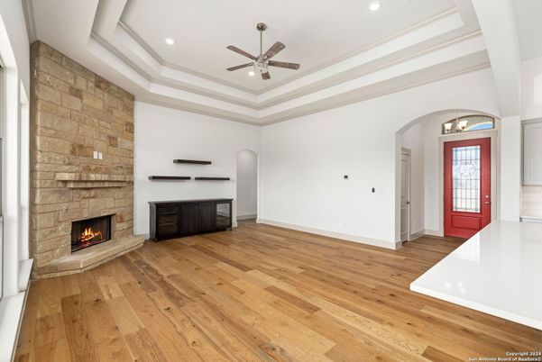 Empty room, Fireplace, Interior, Recessed Lighting, Stone Walls, Wood Texture Flooring