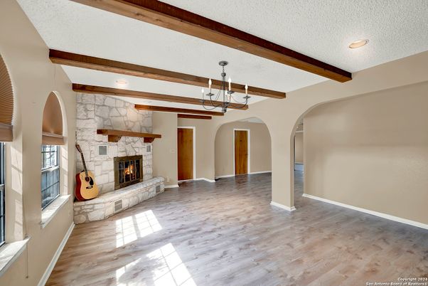 Empty room, Fireplace, Interior, Pendant Lights, Recessed Lighting, Stone Walls, Wooden Beams, Wood Texture Flooring