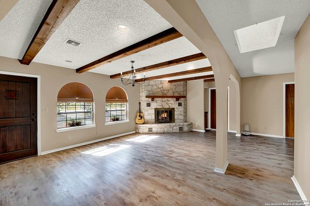 Chandelier, Empty room, Fireplace, Interior, Recessed Lighting, Wooden Beams, Wood Texture Flooring