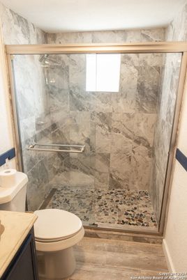 Bathroom, Glass Shower, Interior, Marble Walls, Wood Texture Flooring