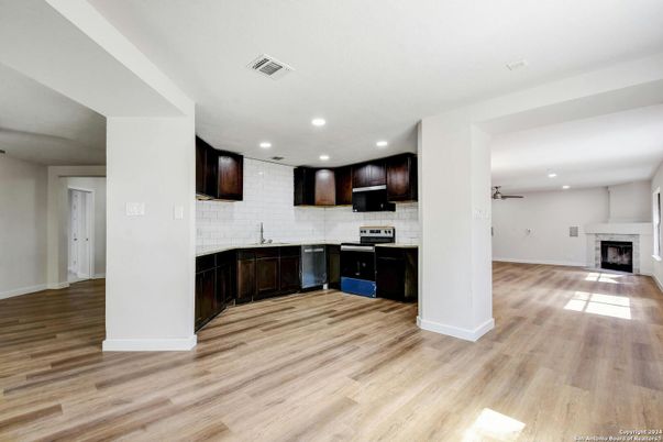 Empty room, Fireplace, Interior, Kitchen, Recessed Lighting, Stone Walls, Wood Texture Flooring