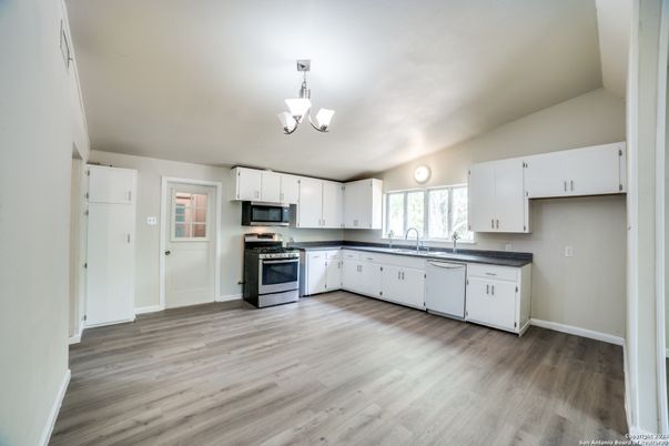 Chandelier, Interior, Kitchen, Pendant Lights, Stainless Steel Appliances, Wood Texture Flooring