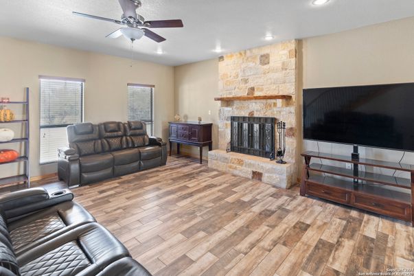 Fireplace, Interior, Living room, Recessed Lighting, Stone Walls, Wood Texture Flooring
