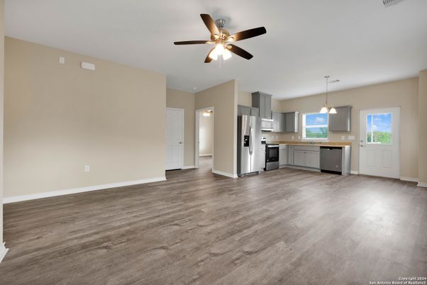 Empty room, Interior, Kitchen, Pendant Lights, Stainless Steel Appliances, Wood Texture Flooring
