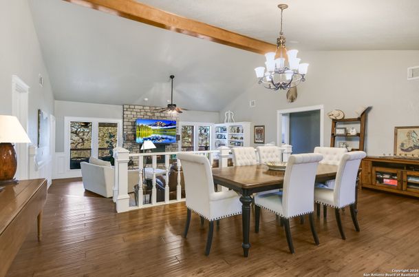 Chandelier, Dining room, Fireplace, Interior, Living room, Stone Walls, Wooden Beams, Wood Texture Flooring