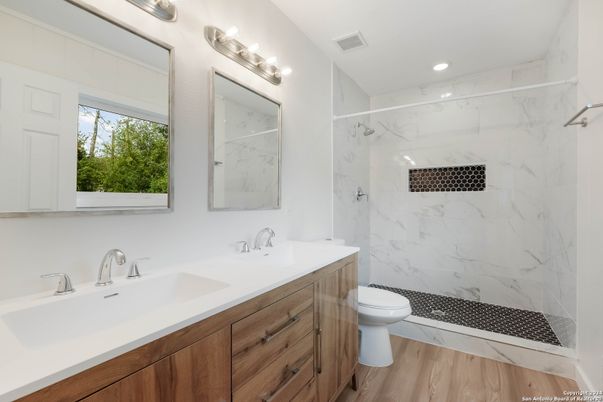 Bathroom, Dual Sink Vanities, Interior, Marble Walls, Recessed Lighting, Wood Texture Flooring