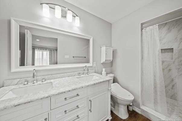 Bathroom, Dual Sink Vanities, Interior, Marble Walls, Wood Texture Flooring