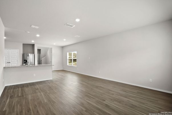 Empty room, Interior, Kitchen, Recessed Lighting, Stainless Steel Appliances, Wood Texture Flooring