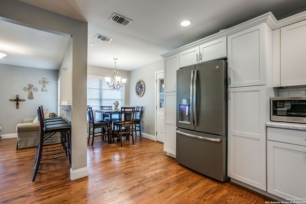 Chandelier, Dining room, Interior, Kitchen, Recessed Lighting, Stainless Steel Appliances, Wood Texture Flooring