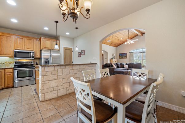 Chandelier, Dining room, Interior, Kitchen, Living room, Pendant Lights, Recessed Lighting, Stainless Steel Appliances, Wooden Ceilings
