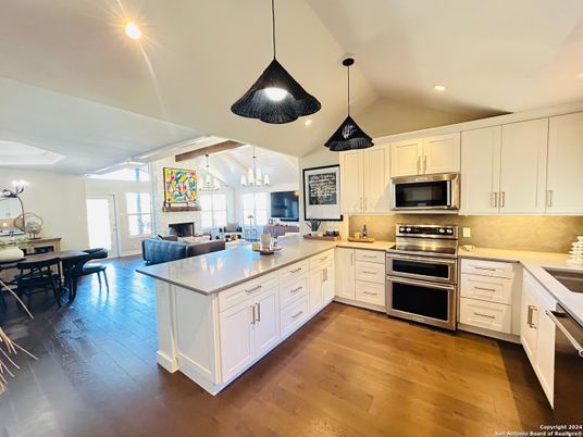 Dining room, Fireplace, Interior, Kitchen, Pendant Lights, Recessed Lighting, Stainless Steel Appliances, Wood Texture Flooring