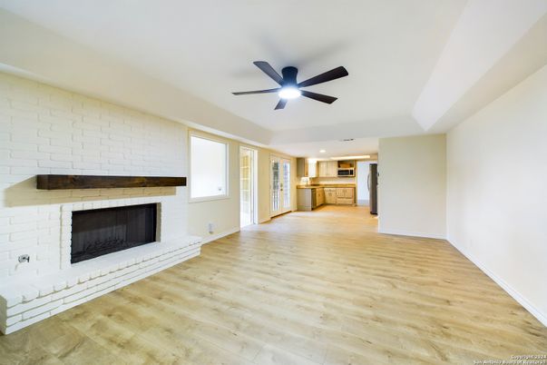 Empty room, Fireplace, Interior, Kitchen, Recessed Lighting, Stone Walls, Wood Texture Flooring