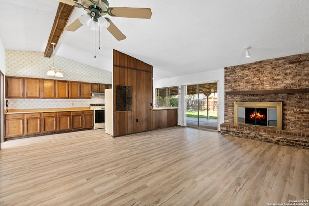 Fireplace, Interior, Kitchen, Pendant Lights, Stainless Steel Appliances, Stone Walls, Wood Texture Flooring