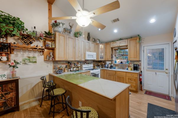 Interior, Kitchen, Recessed Lighting, Tile Countertops, Wood Texture Flooring