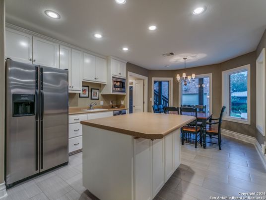 Chandelier, Dining room, Interior, Kitchen, Pendant Lights, Recessed Lighting, Stainless Steel Appliances, Wood Texture Flooring