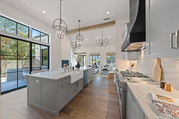 Chandelier, Interior, Kitchen, Living room, Pendant Lights, Recessed Lighting, Stainless Steel Appliances, Wood Texture Flooring