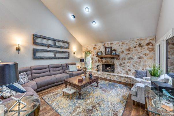 Fireplace, Interior, Living room, Recessed Lighting, Stone Walls, Wood Texture Flooring