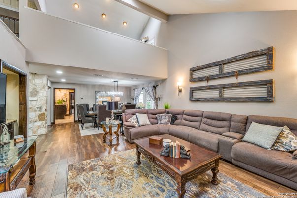 Chandelier, Dining room, Interior, Living room, Pendant Lights, Recessed Lighting, Stone Walls, Wood Texture Flooring