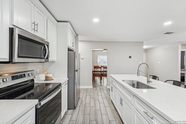 Dining room, Interior, Kitchen, Recessed Lighting, Stainless Steel Appliances, Wood Texture Flooring