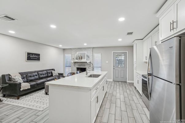 Fireplace, Interior, Kitchen, Living room, Recessed Lighting, Stainless Steel Appliances, Wood Texture Flooring