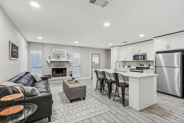 Fireplace, Interior, Kitchen, Living room, Recessed Lighting, Stainless Steel Appliances, Stone Walls, Wood Texture Flooring