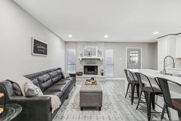 Fireplace, Interior, Living room, Recessed Lighting, Stone Walls, Wood Texture Flooring