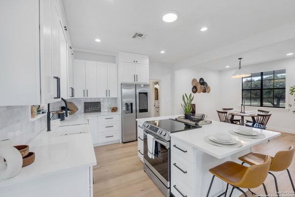 Dining room, Interior, Kitchen, Pendant Lights, Recessed Lighting, Stainless Steel Appliances, Wood Texture Flooring