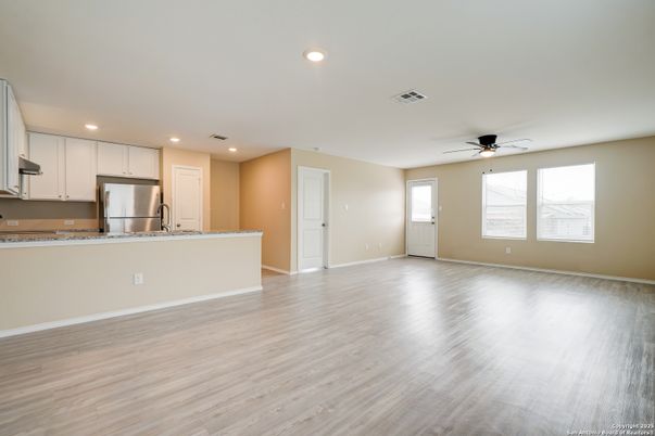 Empty room, Interior, Kitchen, Recessed Lighting, Stainless Steel Appliances, Wood Texture Flooring