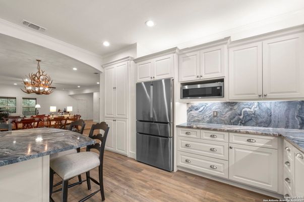 Chandelier, Dining room, Interior, Kitchen, Recessed Lighting, Stainless Steel Appliances, Wood Texture Flooring