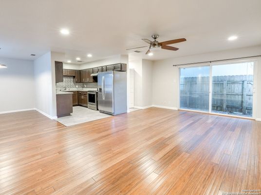 Empty room, Interior, Kitchen, Recessed Lighting, Stainless Steel Appliances, Wood Texture Flooring