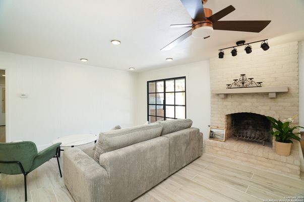 Fireplace, Interior, Living room, Recessed Lighting, Stone Walls, Wood Texture Flooring