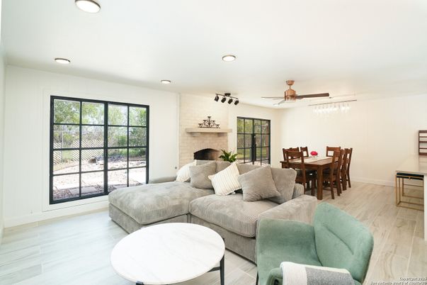 Dining room, Fireplace, Interior, Living room, Recessed Lighting, Stone Walls, Wood Texture Flooring