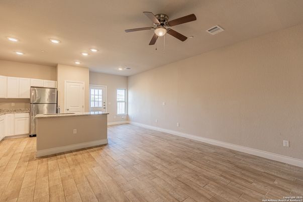 Empty room, Interior, Kitchen, Recessed Lighting, Stainless Steel Appliances, Wood Texture Flooring