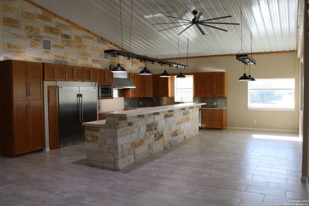 Interior, Kitchen, Pendant Lights, Stainless Steel Appliances, Stone Walls, Wood Texture Flooring