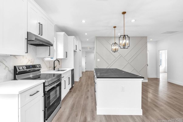 Interior, Kitchen, Marble Walls, Pendant Lights, Recessed Lighting, Stainless Steel Appliances, Wood Texture Flooring