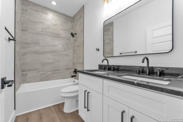Bathroom, Dual Sink Vanities, Interior, Marble Walls, Recessed Lighting, Wood Texture Flooring