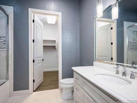 Bathroom, Dual Sink Vanities, Glass Shower, Interior, Marble, Wood Texture Flooring