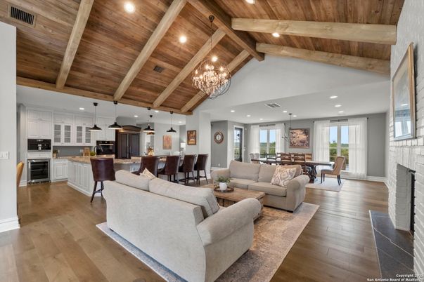 Chandelier, Dining room, Fireplace, Interior, Kitchen, Living room, Pendant Lights, Recessed Lighting, Stainless Steel Appliances, Wooden Beams, Wooden Ceilings, Wood Texture Flooring