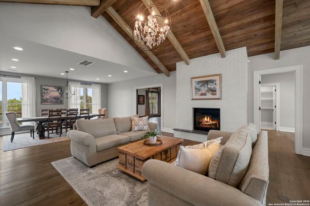 Chandelier, Dining room, Fireplace, Interior, Living room, Pendant Lights, Recessed Lighting, Stone Walls, Wooden Beams, Wooden Ceilings, Wood Texture Flooring