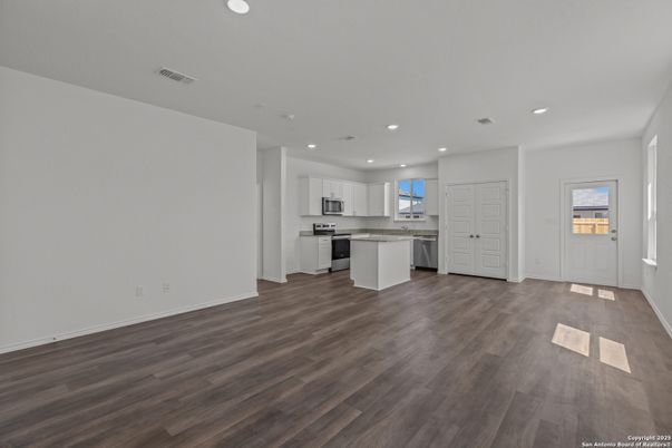 Empty room, Interior, Kitchen, Recessed Lighting, Stainless Steel Appliances, Wood Texture Flooring
