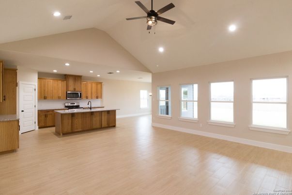 Empty room, Interior, Kitchen, Recessed Lighting, Stainless Steel Appliances, Wood Texture Flooring